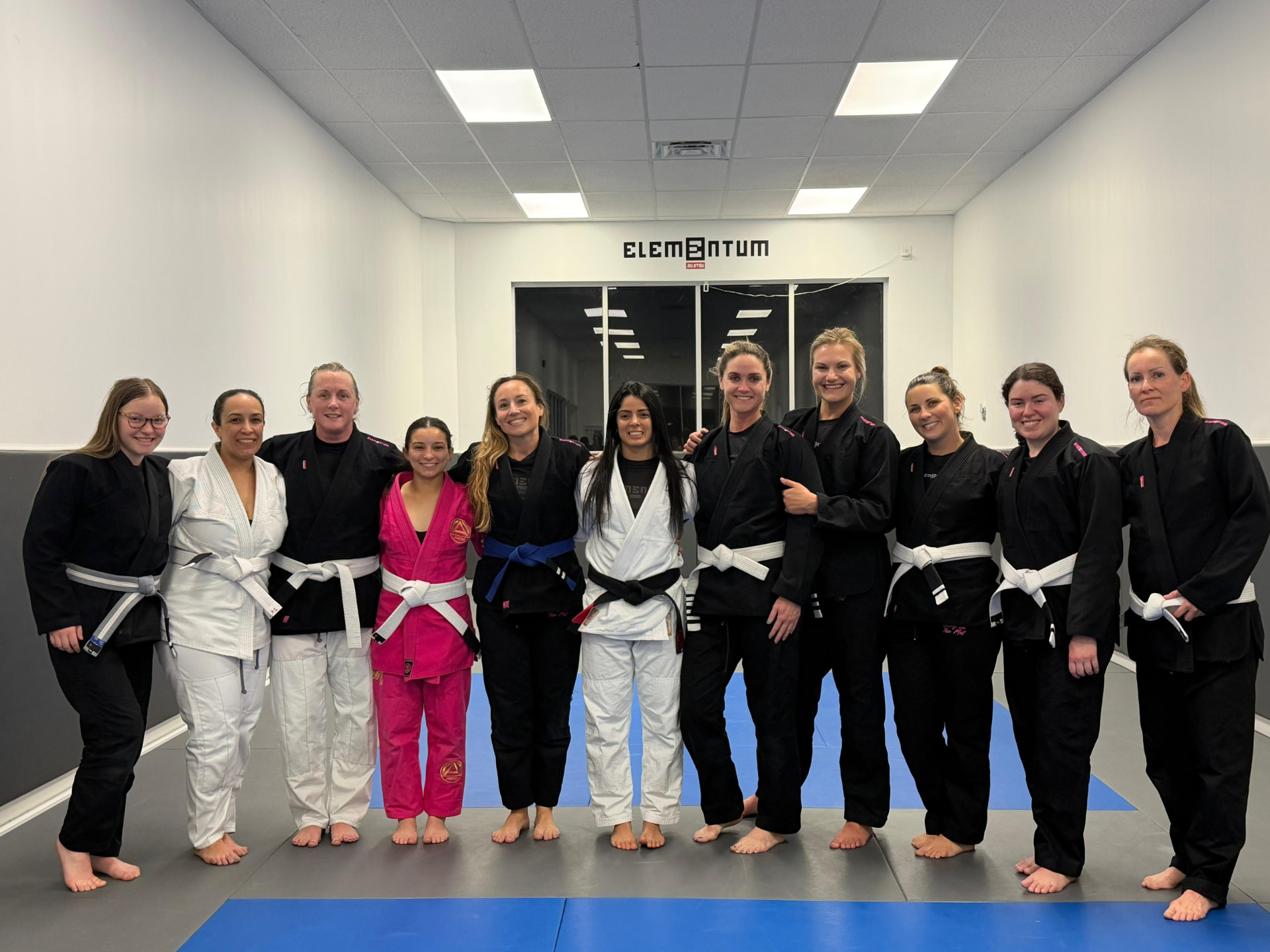 Girls on the Mat class group photo on the mats